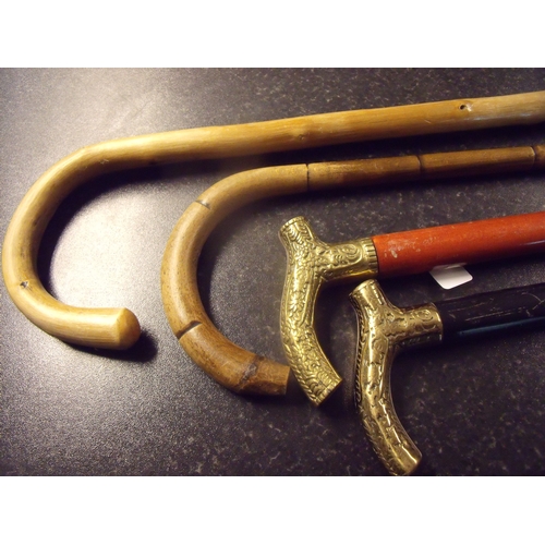 28 - Two brass handled walking sticks and two others (4)