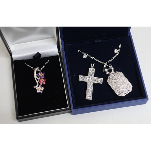 16 - Swarovski crucifix pendant, necklace, earrings, further pendants, a silver necklace and a flower hea... 