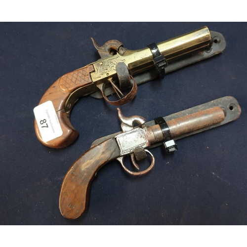 87 - 19th C brass double barrelled percussion cap pocket pistol and a single barrelled pocket pistol, wit... 