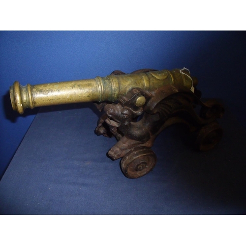 246 - Bronze model cannon with 15 inch stage barrel mounted on iron dragon carriage with four iron wheels