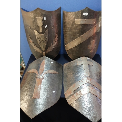 43 - Set of four reproduction steel medieval style knights shields with various crests (approx. 60cm high... 