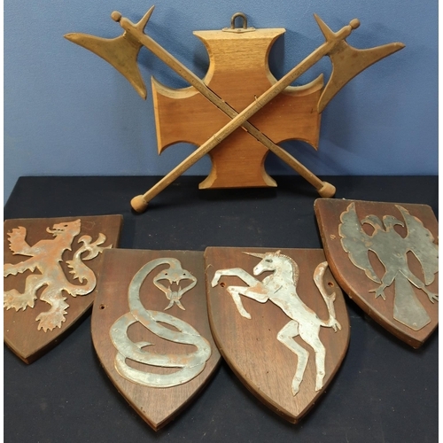 56 - Set of four medieval style crested wall shields and a twin steel axe wall plaque