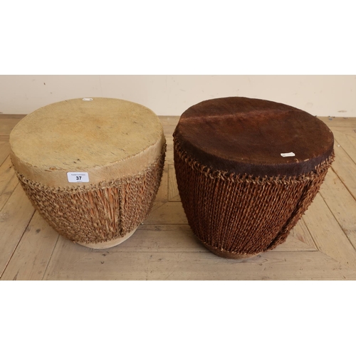 37 - Pair of African style tribal drums finished in animal skin with rope decoration