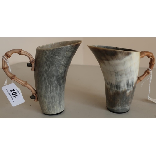102 - Pair of early-mid 20th C cows horn beakers with shaped bamboo handles