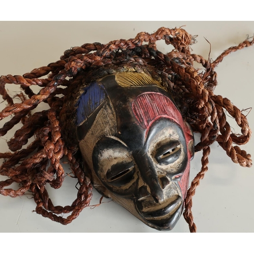 96 - Small African style carved wood face mask with painted detail and hessian ropework hair