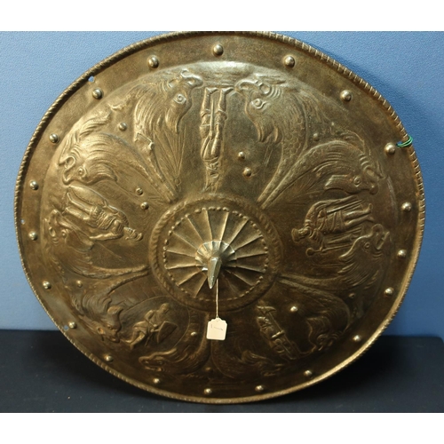 211 - A large metal classical style circular shield (diameter 23 inches), with embossed scenes of dolphins... 