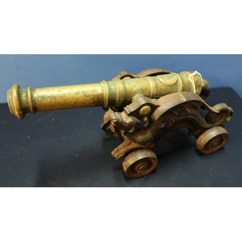 246 - Bronze model cannon with 15 inch stage barrel mounted on iron dragon carriage with four iron wheels