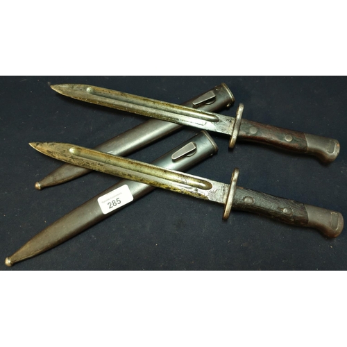 285 - Two circa WWI bayonets with 9 1/2 inch blades with Indian style script, two piece wooden grips and s... 