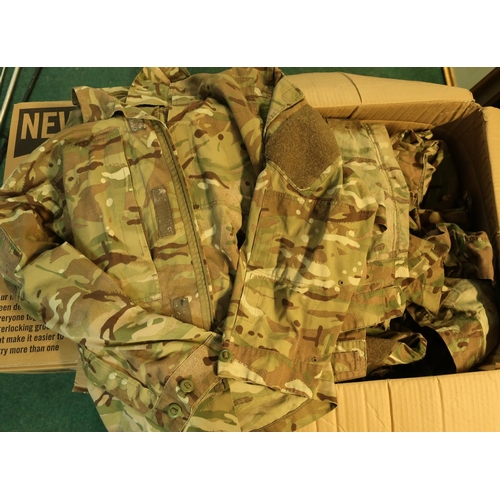 296 - Four boxes containing a large quantity of various British military surplus uniform combats etc