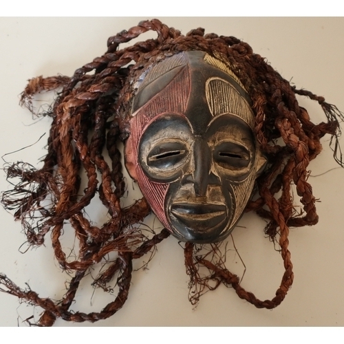 89 - Carved African tribal style face mask with coloured highlighted detail on hessian ropework hair