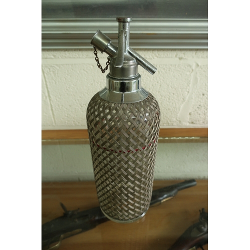 146 - Retro mesh work bound glass soda siphon