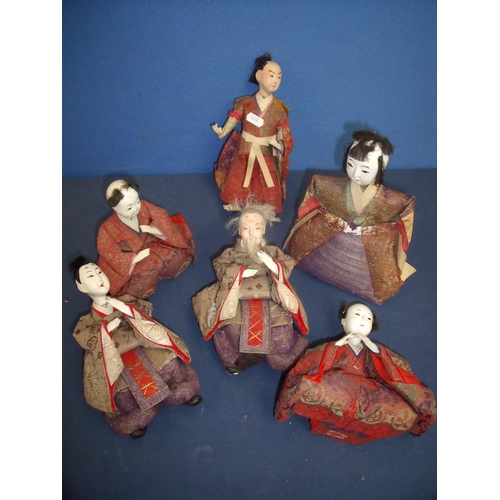 20 - Collection of six Japanese dolls depicting various figures in seated and standing positions, with as... 