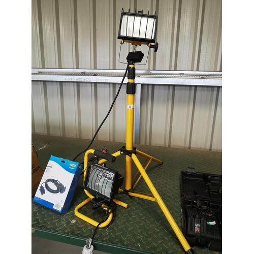 42 - Workshop floodlight on tripod, a similar free standing, and a Ring extension cable