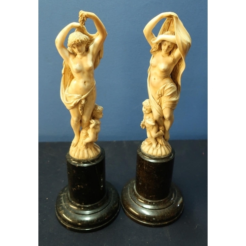 26 - Pair of 19th/20th C French Dieppe carved ivory figures of semi clad maidens with cherubs at their fe... 