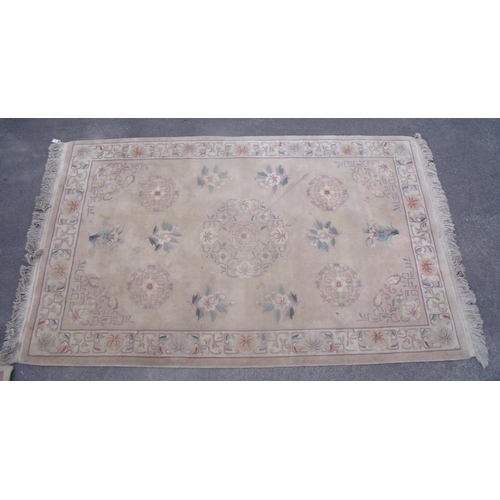202 - Chinese embossed washed wool rug, beige ground with central floral medallion surrounded by floral pa... 