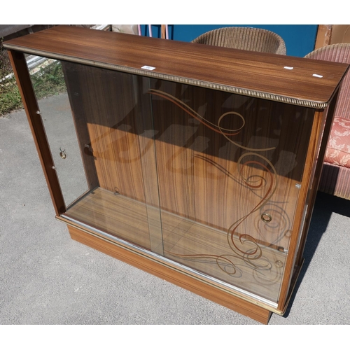 145 - 1950s laminated display cabinet with two glazed shelves enclosed by two sliding glass panelled doors... 