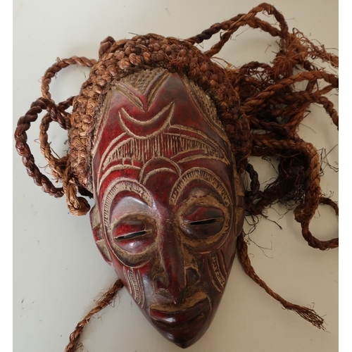 503 - Carved wood African style tribal mask with hessian ropework hair detail (length 33cm)