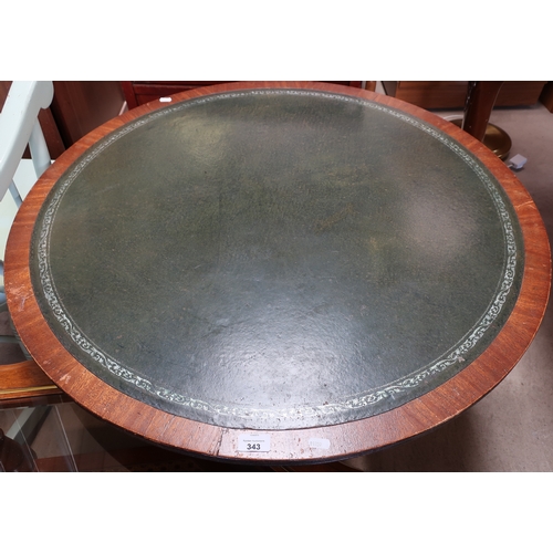 537 - Large mahogany coffee table with leather insert top and three out splayed supports (diameter 91cm)