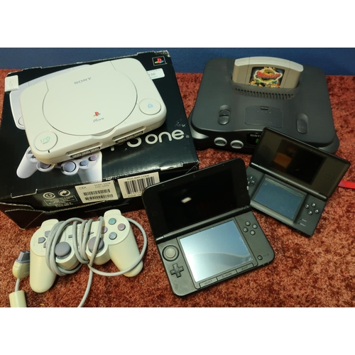 236 - Boxed Sony PS1 and Nintendo 64 with small selection of games