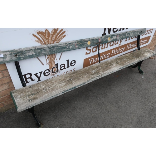 66 - Victorian railway style bench with cast metal supports and planked back and seat, with traces of ste... 