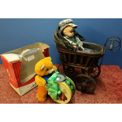 259A - Small dolls vintage metal & wood pram with a bisque headed doll and a battery operated drumming tedd... 