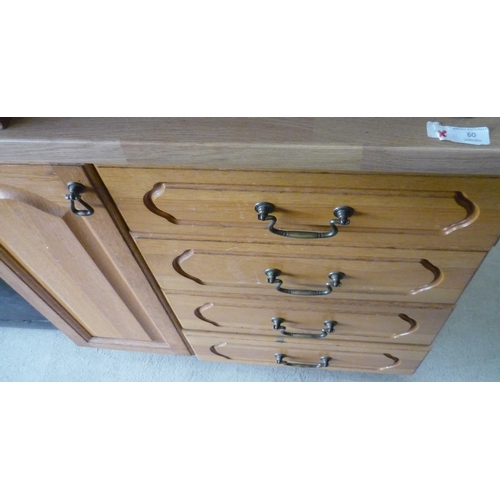 60 - Pine kitchen cabinet on wheels with four drawers and a cupboard door