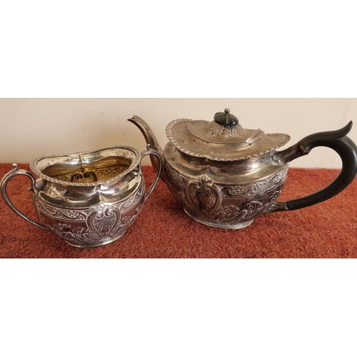 115 - Sheffield silver hallmarked teapot and twin handled sugar basin with embossed detail