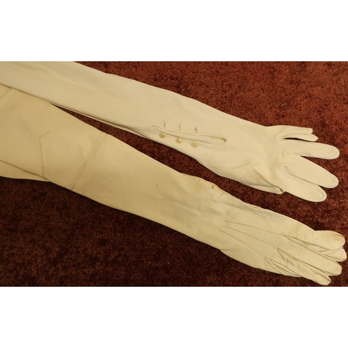171 - Two pairs of ladies long gloves including white kid skin arm length gloves with wrist buttons and a ... 