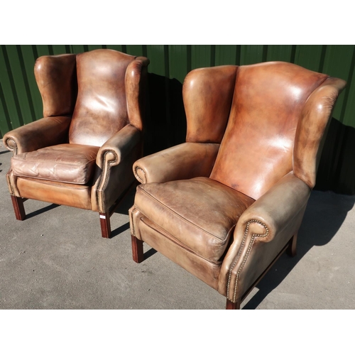 287 - Pair of quality 19th C style tan leather wingback armchairs with brass studded detail and square sup... 