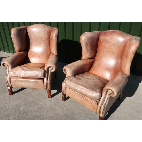 288 - Pair of quality 19th C style tan leather wingback armchairs with brass studded detail and square sup... 