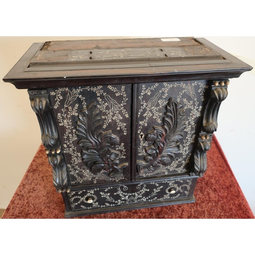 6 - 19th C ebonised table cabinet with bone inlay enclosed by two carved doors with internal shelf secti... 