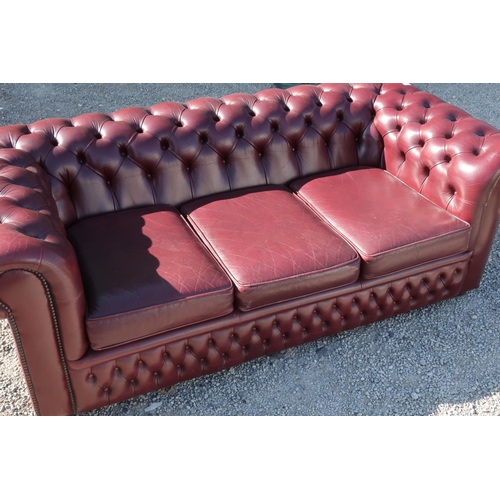 292 - Red leather deep button back three seat Chesterfield sofa (width 195cm)