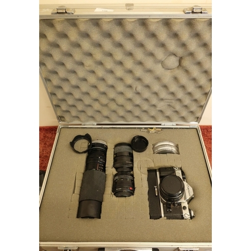 338 - Aluminium flight type case with Canon AE-1 camera with various lenses and accessories