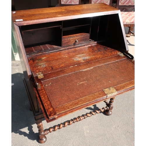 540 - Interwar oak Jacobean style bureau, panelled front opening to reveal partially fitted interior on ba... 