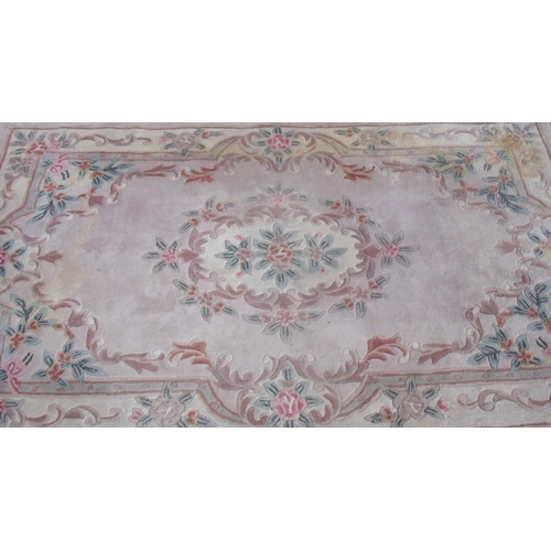 563 - Chinese embossed washed woollen rug, beige ground with floral central medallion and patterned border... 