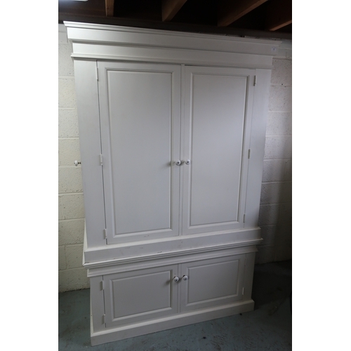 284 - Painted pine combination wardrobe enclosed by two paneled cupboard doors with single internal drawer... 