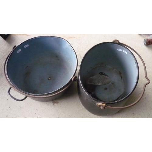 103 - Two large cast metal cooking pots and a cobblers last