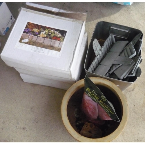 7 - Three boxes and a quantity of garden edging dividers, a pot and bag of rose food