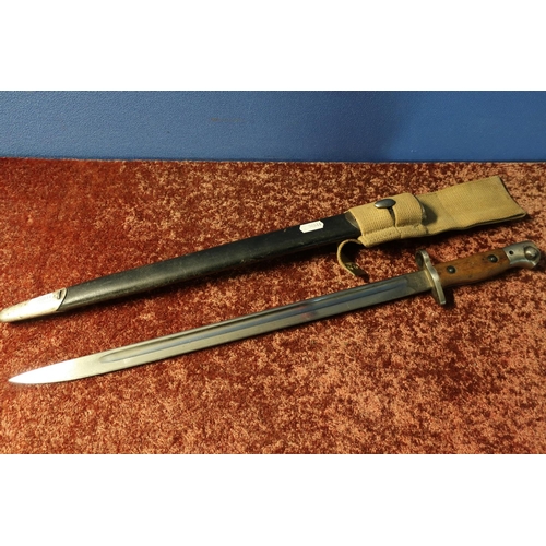 62 - 1907 Wilkinson bayonet with various stamp marks to the blade, two piece wooden grip and complete wit... 