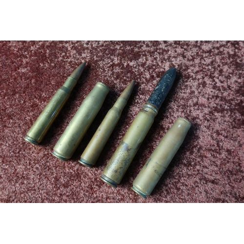 95 - Small section of inert shell casing including a 20MM 1942 round with head, two RA42 rounds and two c... 