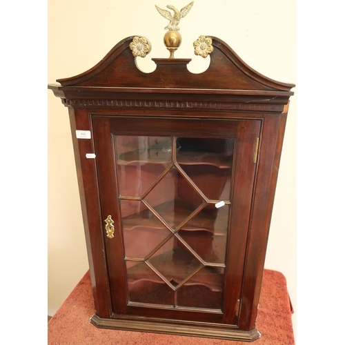 332 - Mahogany corner cupboard with glazed front and brass escutcheon, with brass eagle and ball finial (h... 