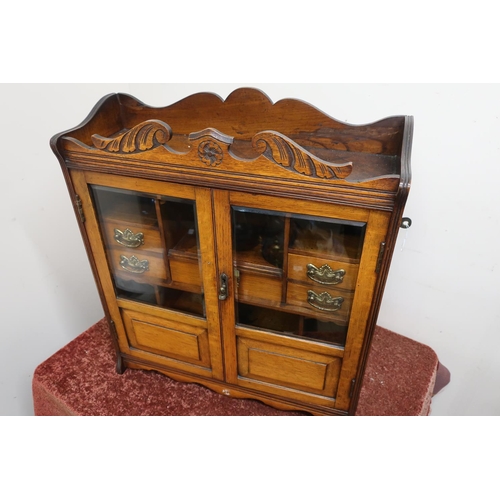 16 - Edwardian mahogany cabinet enclosed by two bevelled edge glazed and panelled cupboard doors revealin... 