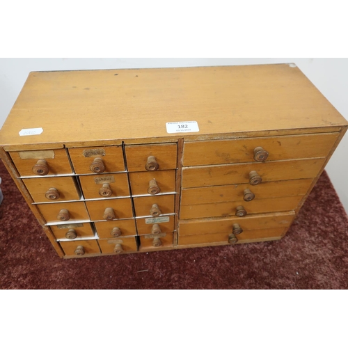 182 - Beech watch makers chest containing peg wood, case strap bars, miscellaneous watch movements etc