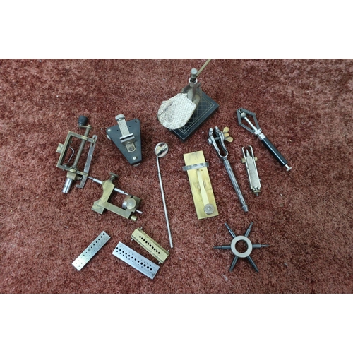 183 - A watch mainspring winder, sleeve spider, miniature vice, hand puller and other items including an i... 