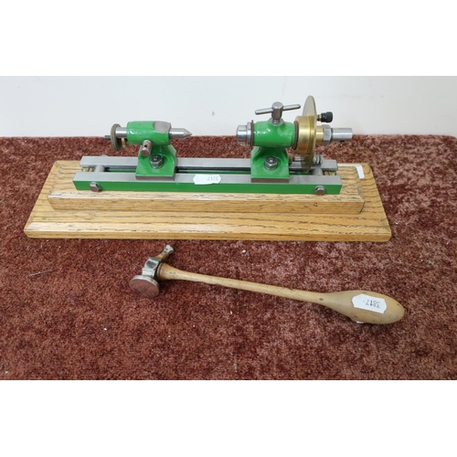 23 - Small engineering type lathe mounted on oak plinth and a small hammer (2)