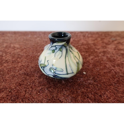 397 - Small squat Moorcroft snowdrop vase, the base marked 2002 (5.5cm high)