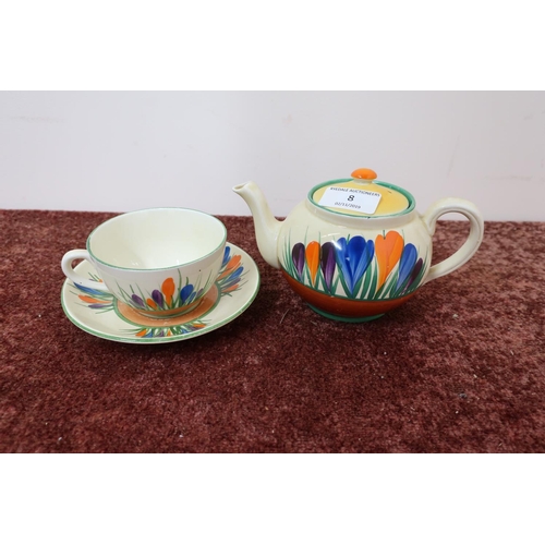 8 - A Bizarre by Clarice Cliff crocus pattern teapot and matching cup and saucer