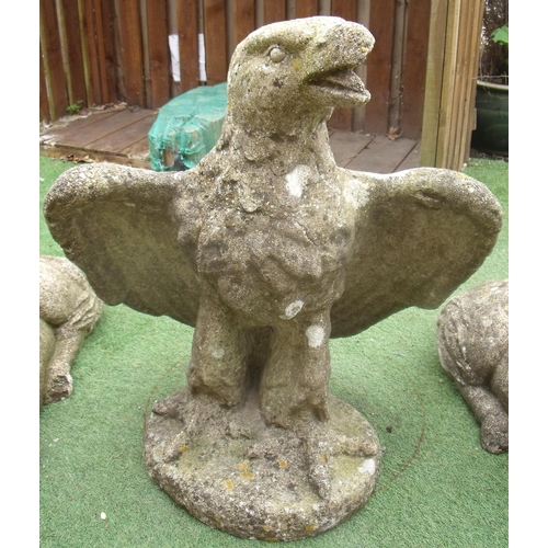 486 - Large composite stone figure of an eagle with wings outspread, on oval base (height 83cm)
