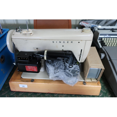 28 - Singer electric sewing machine with carrying case