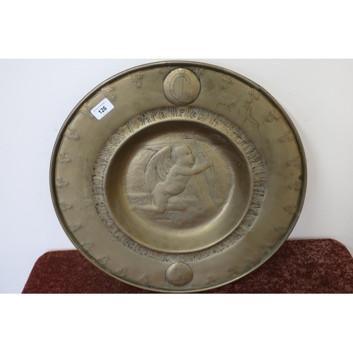 126 - Large brass Arts & Crafts charger with recessed centre decorated with cupid within a border inscribe... 